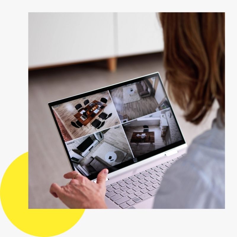 1 woman looking at security feed on laptop